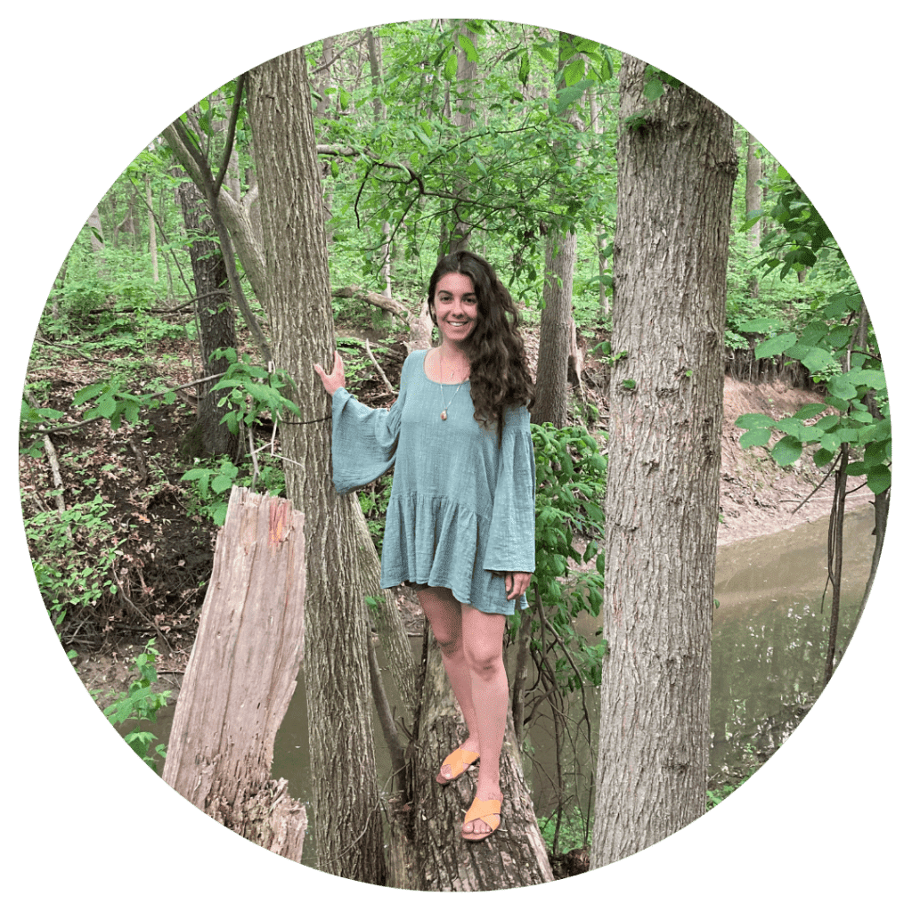 Portrait of Jaylyn standing outdoors among trees by a creek