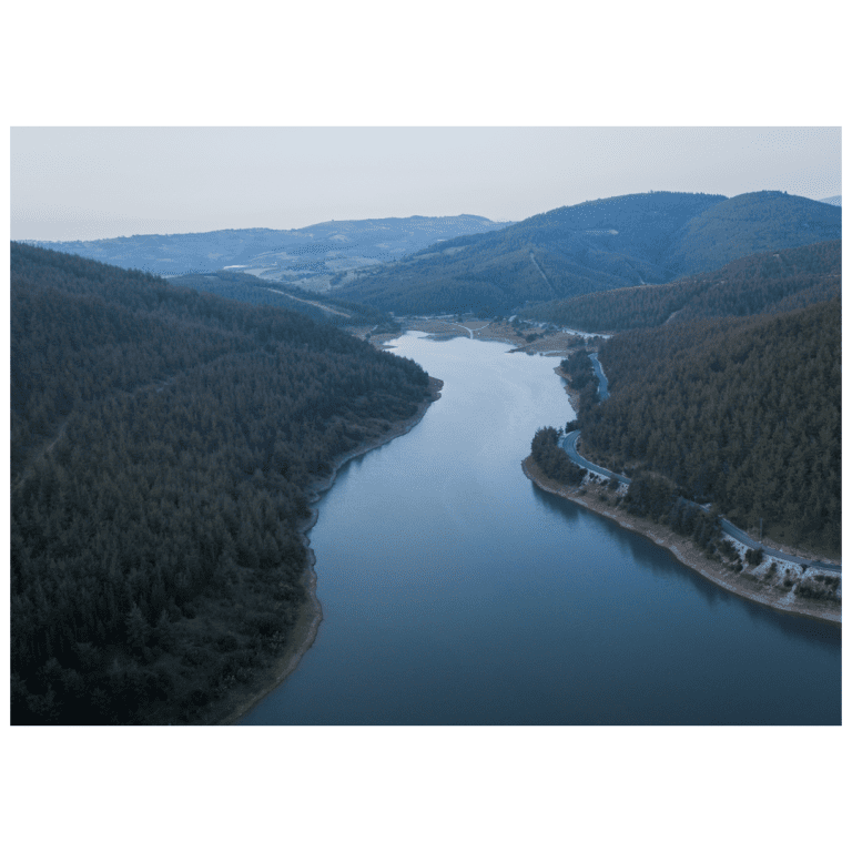 Aerial landscape of a winding lake and forested hills for the Inner Flow Yoga Nidra ritual